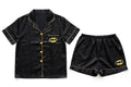 Women's black satin night suit with bat-emblem print – shirt and shorts set